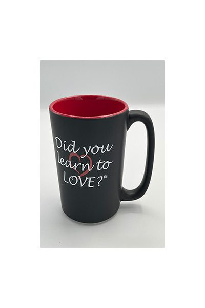 A black coffee mug with the words " did you learn to love ?" written on it.